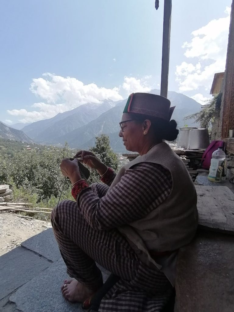 A lady from Kamru village of Kinnaur knitting sweater  